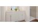 Stylish bathroom with a double vanity, modern fixtures, white cabinets and a tiled walk-in shower at 1514 Wiljohn Rd, Garner, NC 27529