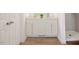 Stylish bathroom with a double vanity, modern fixtures, white cabinets and a tiled walk-in shower at 1514 Wiljohn Rd, Garner, NC 27529