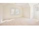 Well-lit bedroom features carpet, neutral walls and large windows for natural light at 1514 Wiljohn Rd, Garner, NC 27529