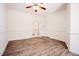 A great bedroom with a ceiling fan, light walls, white trim, and lovely wood flooring at 1514 Wiljohn Rd, Garner, NC 27529