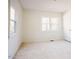 Bedroom with windows, carpeted floor and white walls at 1514 Wiljohn Rd, Garner, NC 27529