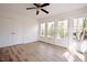 Bright bedroom with a ceiling fan, many windows, a closet, and beautiful wood flooring at 1514 Wiljohn Rd, Garner, NC 27529