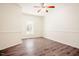 This is an airy bedroom with a ceiling fan, light walls, white trim, and lovely wood flooring at 1514 Wiljohn Rd, Garner, NC 27529
