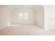 Bright and airy bedroom with dormer windows and neutral carpeting at 1514 Wiljohn Rd, Garner, NC 27529