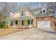 Charming home featuring brick accents, dormer windows, and a welcoming front porch at 1514 Wiljohn Rd, Garner, NC 27529