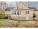 Back of home exterior with a large deck and backyard view of landscaping and trees at 1514 Wiljohn Rd, Garner, NC 27529