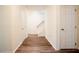 A bright hallway with wood flooring, a staircase, and white trim at 1514 Wiljohn Rd, Garner, NC 27529