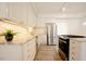 Bright kitchen with stainless appliances, white cabinets, and a center island at 1514 Wiljohn Rd, Garner, NC 27529