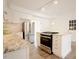 Bright kitchen with stainless appliances, white cabinets, and a center island at 1514 Wiljohn Rd, Garner, NC 27529