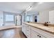 Bright bathroom with granite countertops, white cabinetry, large mirror, soaking tub, and glass shower at 197 Royal Oak Ln, Garner, NC 27529