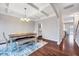 Elegant dining room featuring hardwood floors, coffered ceiling, chandelier, and adjacent to kitchen at 197 Royal Oak Ln, Garner, NC 27529