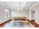 Bright dining room with modern lighting, a wooden table set, and hardwood floors at 197 Royal Oak Ln, Garner, NC 27529