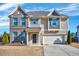 Charming two-story home featuring a brick facade, well-manicured lawn, and attached two-car garage at 197 Royal Oak Ln, Garner, NC 27529
