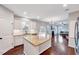 Open kitchen with granite countertops, stainless steel appliances, an island, and hardwood floors at 197 Royal Oak Ln, Garner, NC 27529