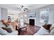 Bright living room featuring hardwood floors, neutral walls, fireplace, and a seamless flow to the open kitchen at 197 Royal Oak Ln, Garner, NC 27529