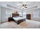 Spacious main bedroom featuring a tray ceiling, plush carpeting, lots of natural light, and neutral paint at 197 Royal Oak Ln, Garner, NC 27529