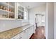 Charming pantry area with granite countertops, white cabinets, and tile backsplash for ample kitchen storage at 197 Royal Oak Ln, Garner, NC 27529