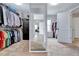 Spacious walk-in closet featuring ample hanging space, shelving, and full-length mirror to an adjacent room at 197 Royal Oak Ln, Garner, NC 27529