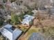Wide aerial shot of the home in a neighborhood setting with mature trees and manicured lawns at 206 Spring Ln, Chapel Hill, NC 27514