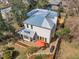 Aerial view of the home showcasing the deck, patio with orange umbrella, and fenced backyard at 206 Spring Ln, Chapel Hill, NC 27514
