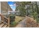 Picturesque backyard featuring lush greenery, a winding pathway, and a charming home exterior at 206 Spring Ln, Chapel Hill, NC 27514