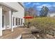 Backyard deck with outdoor seating, grill, and landscaping for relaxing and entertaining at 206 Spring Ln, Chapel Hill, NC 27514
