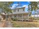 A view of the house's exterior featuring a covered porch, well-maintained garden, and lush landscaping at 206 Spring Ln, Chapel Hill, NC 27514