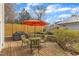 Backyard wooden deck with outdoor table and seating under an orange umbrella at 206 Spring Ln, Chapel Hill, NC 27514