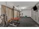 Basement gym equipped with weightlifting equipment and a flatscreen TV for entertainment at 206 Spring Ln, Chapel Hill, NC 27514