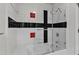 Unique bathroom showcases a tiled shower and tub with a glass enclosure, decorated with a distinctive design at 206 Spring Ln, Chapel Hill, NC 27514