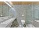Modern bathroom featuring custom tile, an integrated sink, and glass shower door at 206 Spring Ln, Chapel Hill, NC 27514