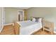 Comfortable bedroom with wood floors, a queen-sized bed with decorative pillows, and natural-wood nightstand at 206 Spring Ln, Chapel Hill, NC 27514