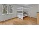 Bright bedroom featuring a white bunk bed, hardwood floors, and natural light from multiple windows, perfect for  at 206 Spring Ln, Chapel Hill, NC 27514
