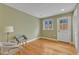 Relaxing bedroom with hardwood floors, a cozy seating area with two stylish chairs, and a bright window at 206 Spring Ln, Chapel Hill, NC 27514