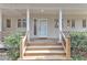 Welcoming front entrance featuring a well-lit porch with a classic door and manicured landscaping at 206 Spring Ln, Chapel Hill, NC 27514