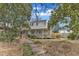 Charming two-story home with a welcoming porch and mature trees surrounding the property at 206 Spring Ln, Chapel Hill, NC 27514