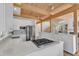 Bright kitchen features wood beam ceiling, stainless steel appliances, white cabinetry and an open floorplan at 206 Spring Ln, Chapel Hill, NC 27514