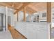 Bright kitchen features wood beam ceiling, expansive white cabinetry and an open floorplan into the living space at 206 Spring Ln, Chapel Hill, NC 27514
