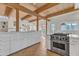 Bright kitchen featuring stainless steel appliances, expansive white cabinetry and an open floorplan into the living space at 206 Spring Ln, Chapel Hill, NC 27514