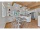 A sleek modern kitchen with white cabinets, stainless steel appliances, an island, and adjacent dining area at 206 Spring Ln, Chapel Hill, NC 27514