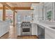 Bright kitchen featuring stainless steel appliances, white cabinetry, with an open floorplan into the dining space at 206 Spring Ln, Chapel Hill, NC 27514