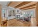 Living room featuring wooden ceilings, fireplace, hardwood floors, built-in cabinets, and access to backyard at 206 Spring Ln, Chapel Hill, NC 27514