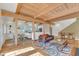 Spacious living room with exposed beams, hardwood floors, fireplace, and open kitchen view at 206 Spring Ln, Chapel Hill, NC 27514