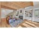 Bright living room featuring a fireplace, hardwood floors, skylights, exposed beams, and built-in bookshelves at 206 Spring Ln, Chapel Hill, NC 27514