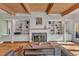 Living room with fireplace, hardwood floors, built-in shelving, and natural light at 206 Spring Ln, Chapel Hill, NC 27514