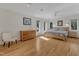 Bright main bedroom features hardwood floors, tray ceiling, large windows, and neutral decor at 206 Spring Ln, Chapel Hill, NC 27514