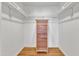 Spacious walk-in closet features hardwood floors, white walls, and a natural-wood dresser with multiple drawers at 206 Spring Ln, Chapel Hill, NC 27514