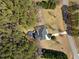 Aerial view of property showcasing a well-maintained yard, in-ground pool and surrounding greenery at 208 Hunting Lodge Rd, Clayton, NC 27520
