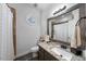Bathroom features granite countertop, decorative mirror and fixtures, and walk-in shower at 208 Hunting Lodge Rd, Clayton, NC 27520