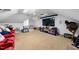 Large bonus room featuring a flat screen television with red theater seats and neutral carpeting at 208 Hunting Lodge Rd, Clayton, NC 27520